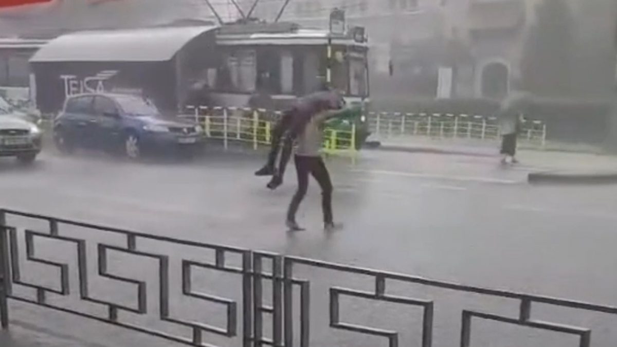 Așa ceva doar la Iași există! Să se apere de ploaie, un bărbat și-a luat pe sus prietenul, l-a pus deasupra capului și a fugit cu el spre stația de tramvai. Trecătorii au rămas șocați – FOTO/VIDEO